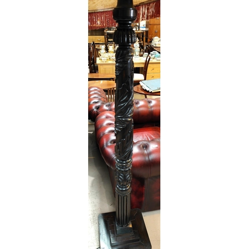 884 - An early 20th century standard lamp in carved and turned mahogany