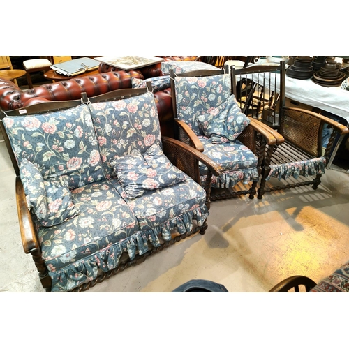 904 - An early 20th century oak barley twist and bergère two seater settee with matching armchairs,... 