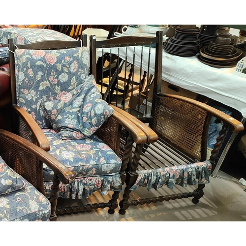 904 - An early 20th century oak barley twist and bergère two seater settee with matching armchairs,... 