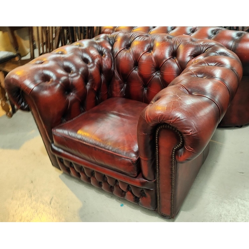 995 - A traditional red leather deeply buttoned back single armchair with scrolling back