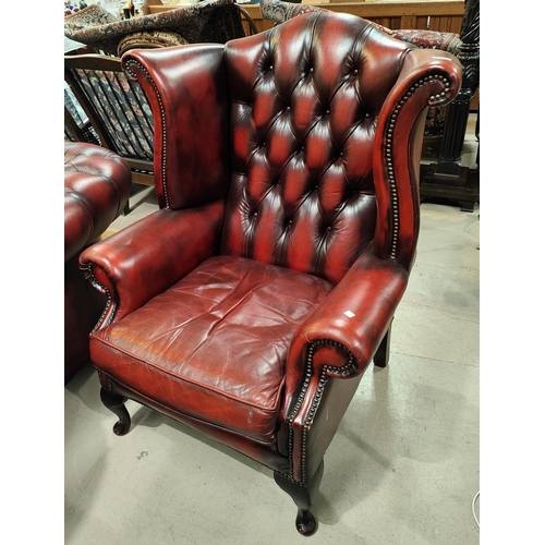 998 - A high back traditional Chesterfield armchair in red leather upholstery 