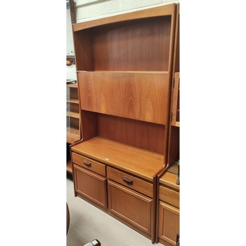 878 - A mid 20th century teak wall unit with fall front drinks cabinet, double drawers and cupboard below,... 