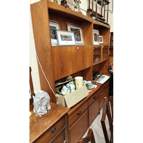 878 - A mid 20th century teak wall unit with fall front drinks cabinet, double drawers and cupboard below,... 