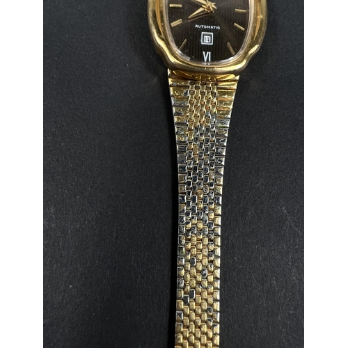 561D - BULOVA: a vintage gold plated automatic watch with brown dial, gold hands, seconds sweep and baton m... 