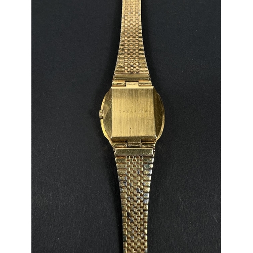 561D - BULOVA: a vintage gold plated automatic watch with brown dial, gold hands, seconds sweep and baton m... 