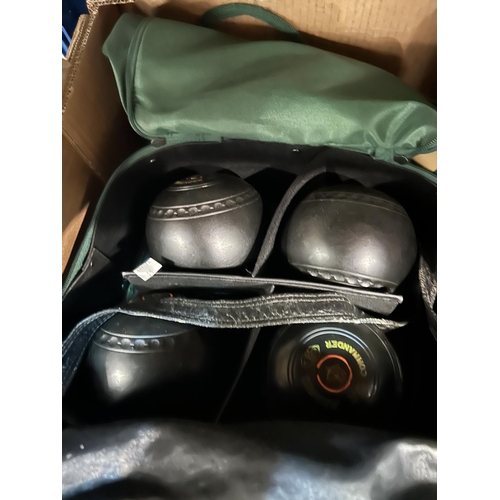 13 - A pair of crown green bowls in bag; a set of 4 lawn bowls in bag