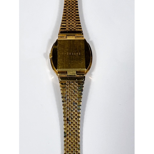 561D - BULOVA: a vintage gold plated automatic watch with brown dial, gold hands, seconds sweep and baton m... 
