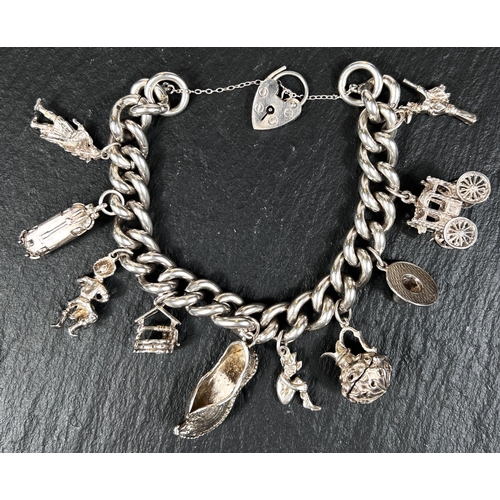 577 - A hallmarked silver charm bracelet with 10 charms, 3oz