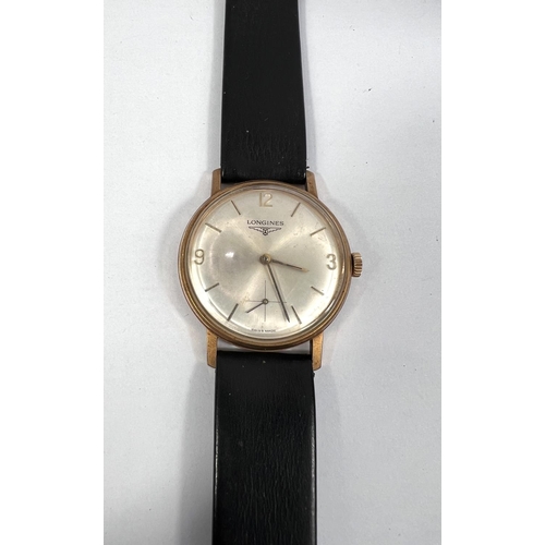 582 - A gent's presentation wristwatch by Longines, 9 carat hallmarked gold on black leather strap, inscri... 