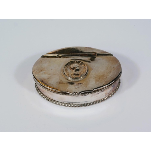 599 - A 19th century oval white metal snuff box with 1806 coin top, hinged lid and piecrust border