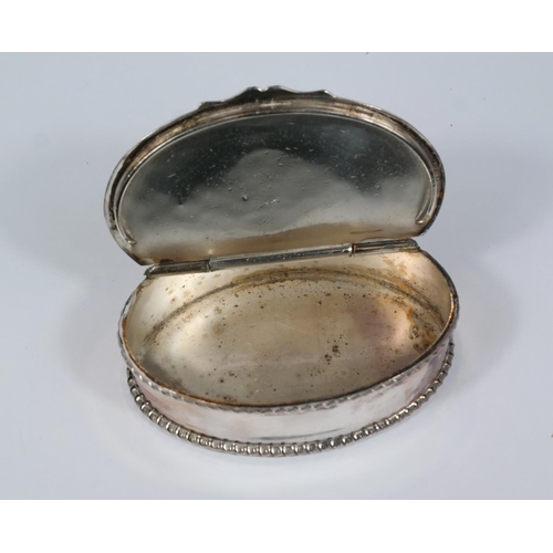 599 - A 19th century oval white metal snuff box with 1806 coin top, hinged lid and piecrust border