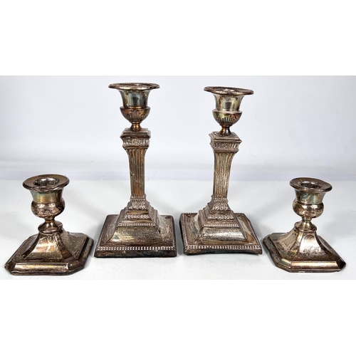 606 - A pair of square reed column hallmarked silver candlesticks on weighted bases, Sheffield 1926 ht. 17... 