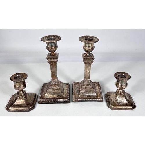 606 - A pair of square reed column hallmarked silver candlesticks on weighted bases, Sheffield 1926 ht. 17... 