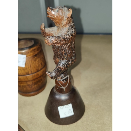 5A - A Black Forrest carved bell in the form of a dancing bear, a carved wooden ink well and a similar ba... 