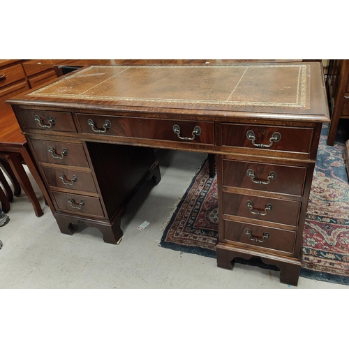 742 - A reproduction mahogany kneehole desk with inset leather top and 9 drawers