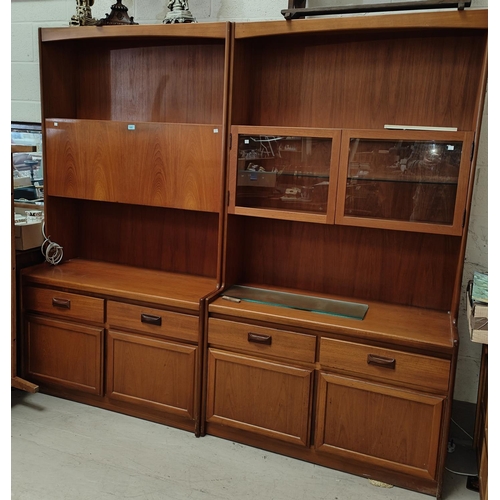 878 - A mid 20th century teak wall unit with fall front drinks cabinet, double drawers and cupboard below,... 