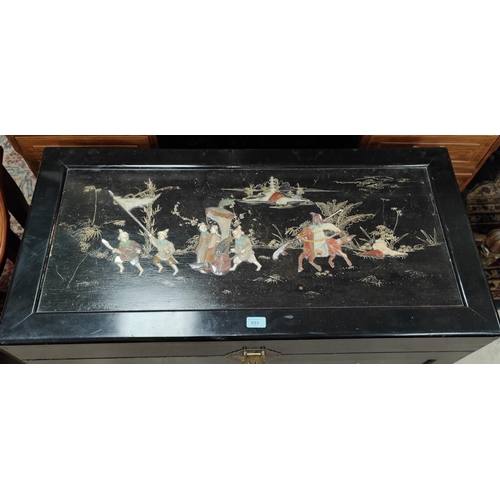 893 - A mid 20th century Chinese black lacquer blanket chest with simulated hardstone relief figures in pr... 