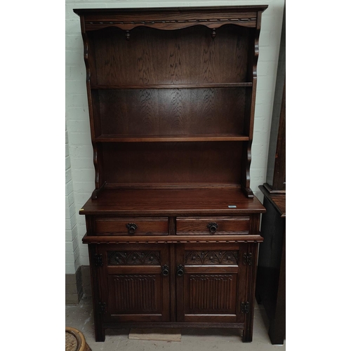 907 - An reproduction oak Old Charm Welsh dresser with two height shelves and cupboards and drawers below