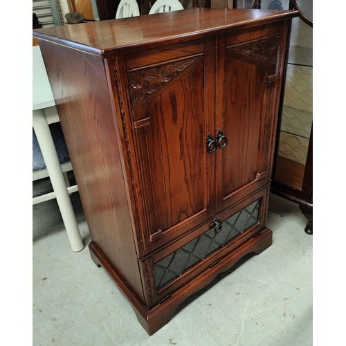 745 - A reproduction carved oak TV cabinet in the Titchmarsh & Goodwin manner