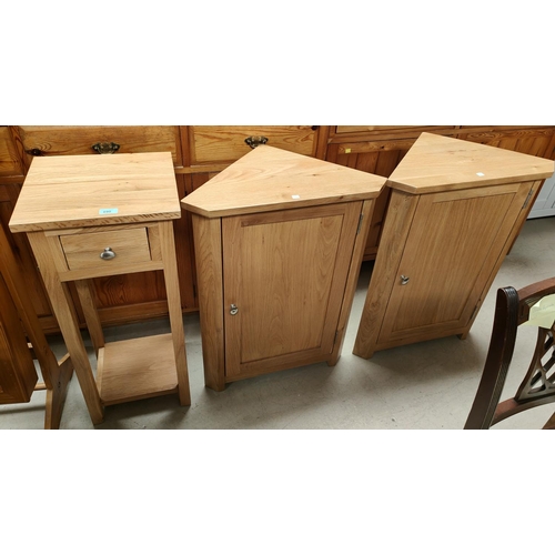 890 - A pair of modern light oak wall hanging corner cabinets enclosed by a single door + a similar 2 heig... 