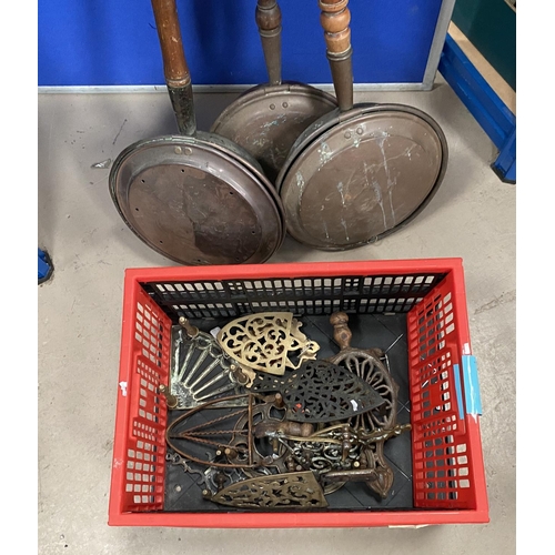 36 - 3 copper warming pans; a selection of trivets and other brassware.