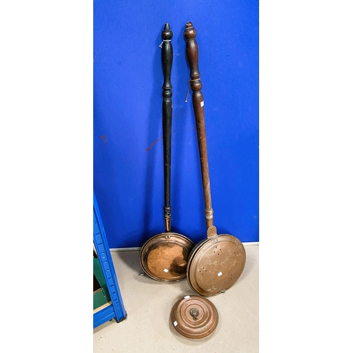 37 - 2 copper warming pans and a 19th century copper coal helmet.