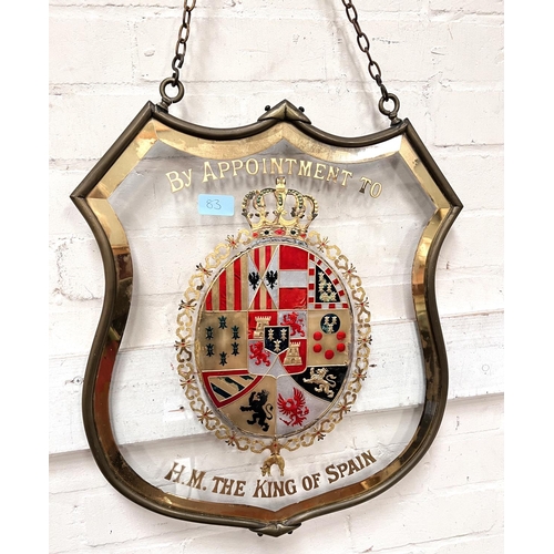 83 - BY APPOINTMENT TO H.M THE KING OF SPAIN, an enamelled and gilt glass armorial pendant shop sign, 52c... 