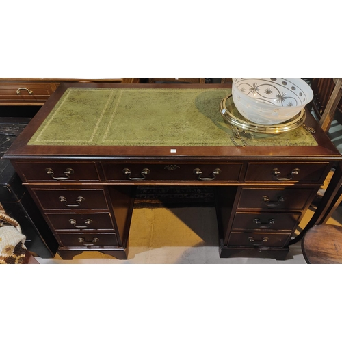 743 - A reproduction mahogany kneehole desk with inset leather top and 9 drawers