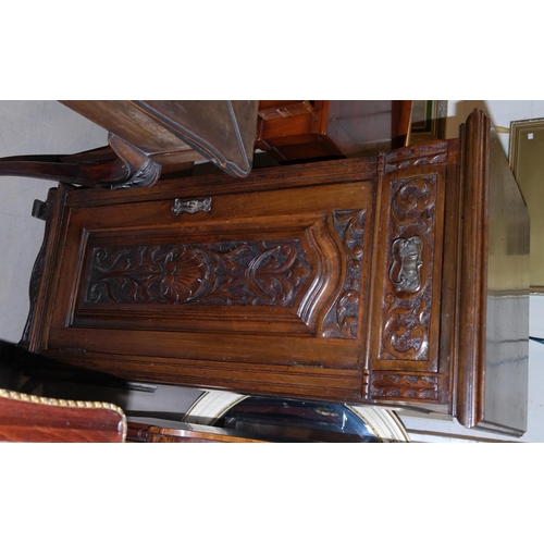 909 - An Edwardian carved mahogany pedestal music cabinet with panelled sides