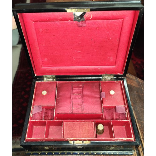 65A - A Victorian Papier Mache sewing box with mother of pearl decoration and red interior.