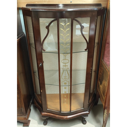 910 - A 1930's display cabinet with bow front, including glass shelves.