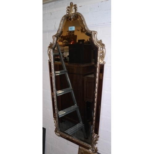 912 - A period style rectangular, bevelled edge wall mirror with arched top, in a gilt frame with peach gl... 