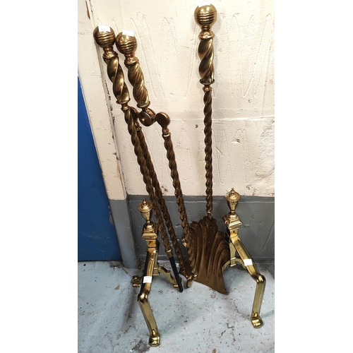 42 - A 19th century set of brass rope twist fire irons and dogs; an unusual rustic planter in the form of... 