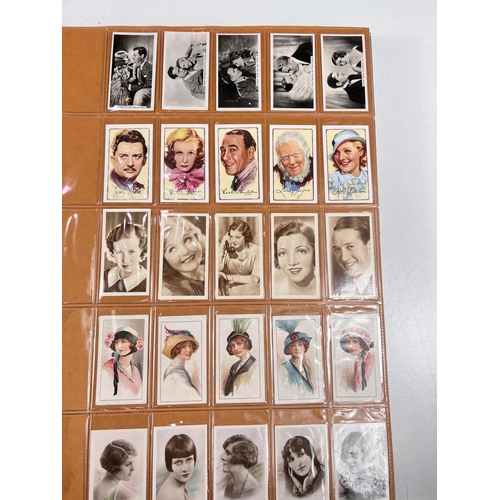 166 - A large album of early 20th century film star cigarette cards; and others