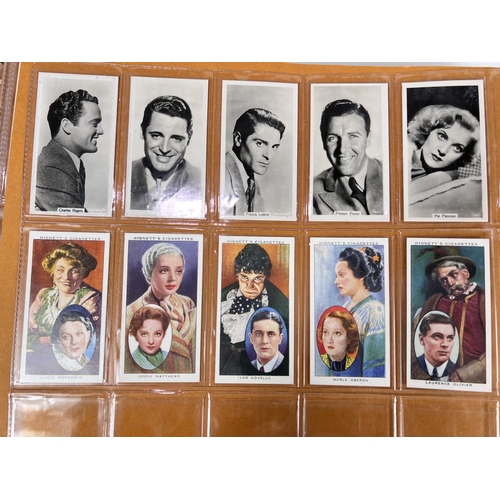 166 - A large album of early 20th century film star cigarette cards; and others