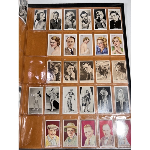 166 - A large album of early 20th century film star cigarette cards; and others