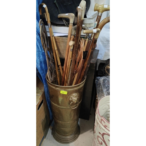 13 - A brass stick stand; a collection of sticks