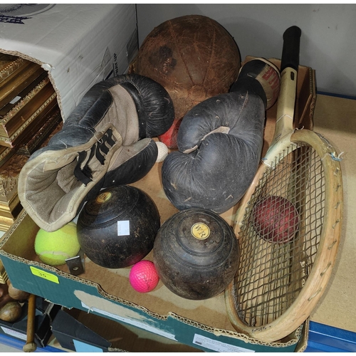 35 - A selection of vintage sporting items:  boxing gloves; medicine ball; bowls; etc.