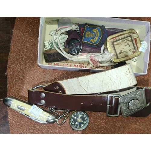 97A - A collection of Scouting and Girl Guide items including badges, belts, compass, pocket knife etc