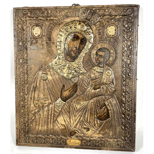 216 - A Russian orthodox metal framed picture of Mary and Jesus on wooden backing