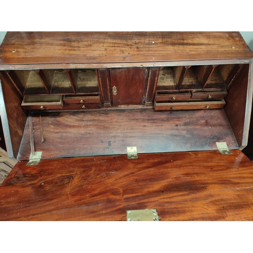 968 - A Georgian mahogany fall front bureau with tall front, fitted interior, 4 long graduating drawers wi... 