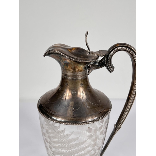 601 - A fern etched glass claret jug with beaded hallmarked silver lid, rim, handle and base