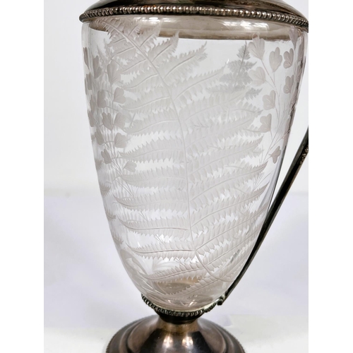 601 - A fern etched glass claret jug with beaded hallmarked silver lid, rim, handle and base