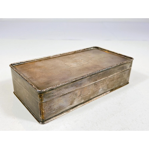 610 - A hallmarked silver rectangular cigarette box with engine turning, Birmingham 1926