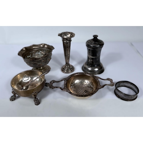 612 - A hallmarked silver tea strainer on stand; a hallmarked silver pepper grinder; glass salt; etc., 6.4... 