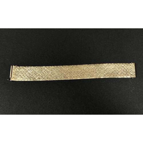 615 - A 9 carat wide reticulated bracelet in bark effect, 51.8gm