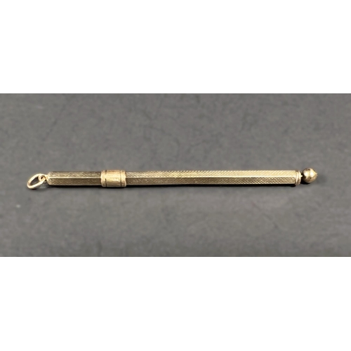 616 - A 9 carat hallmarked gold cocktail stick, retractable with swivel stick, engine turned, 6gm