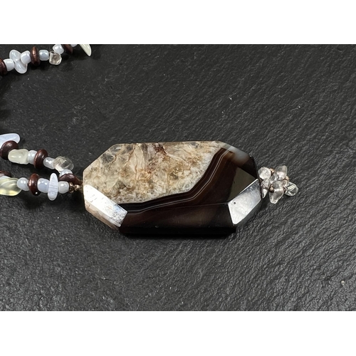 649B - A necklace formed from rough cut polished agate beads with a banded agate pendant drop similar to Bl... 