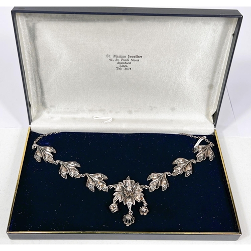 655A - A Victorian silver and gold necklace with 3 leaf shapes set with diamonds to either side of central ... 