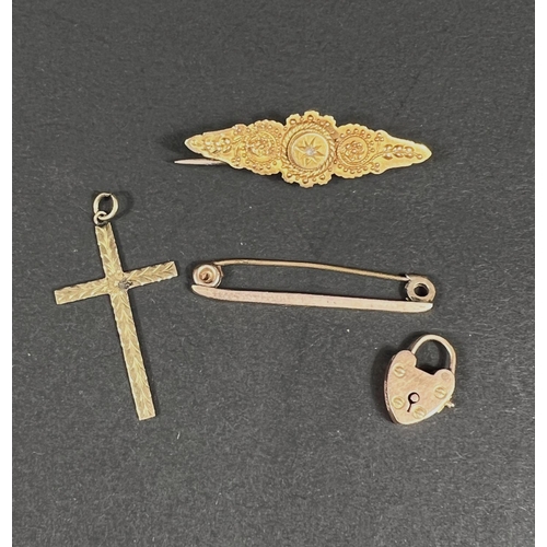 667 - A filigree bar brooch stamped 625; a heart locket stamped 15, 3.8gm; a pendant cross and bar brooch ... 